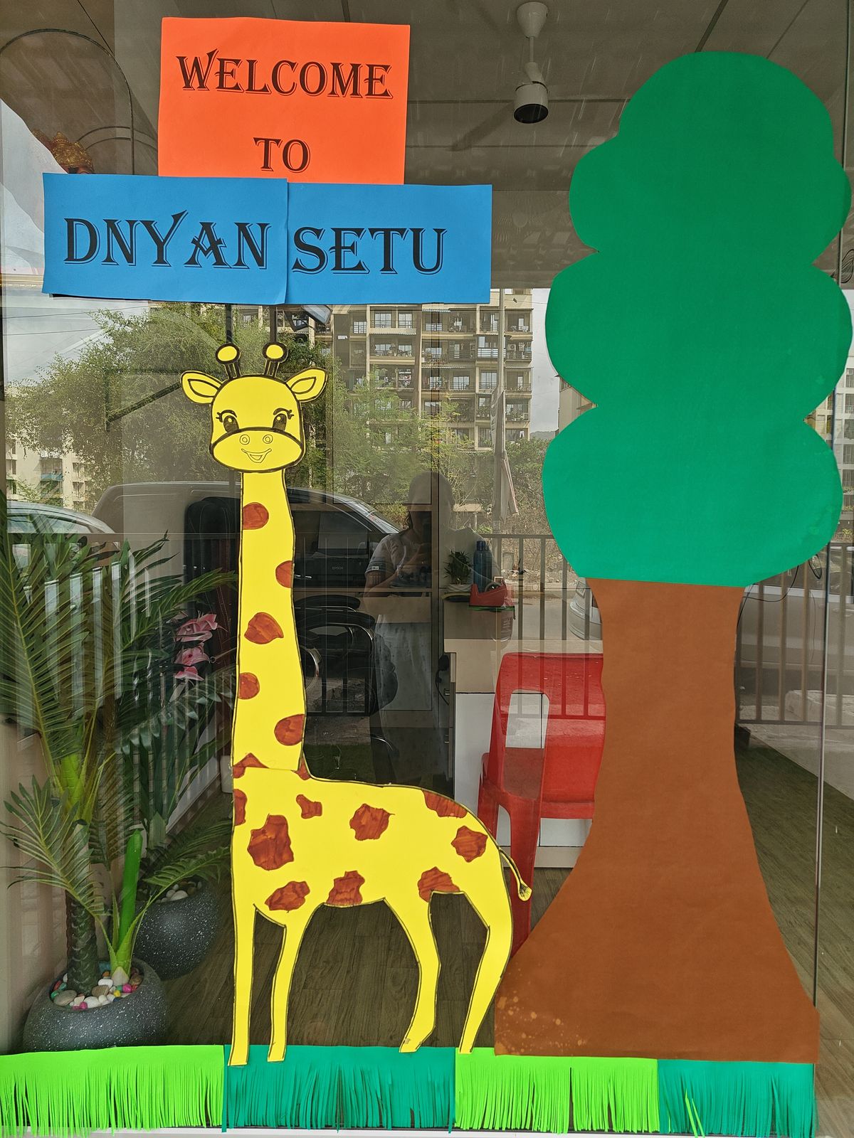 The giraffe at our door — the first friend most children spot.